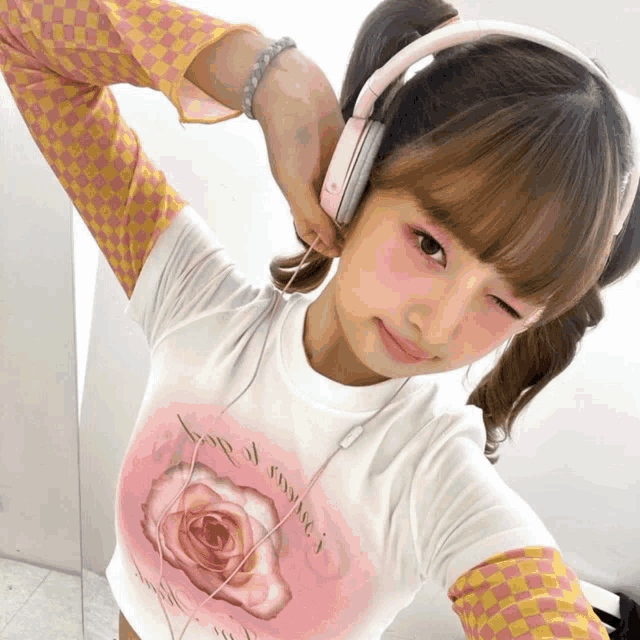 a girl wearing headphones and a t-shirt that says " love of sydney "