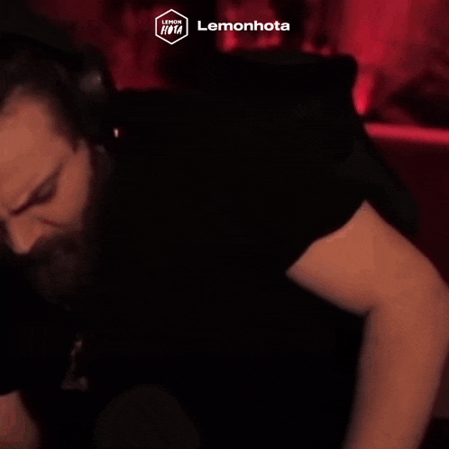 a man with a beard wearing headphones and a black shirt that says lemonhota on the bottom