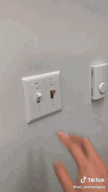 a tiktok video of a person turning a light switch off