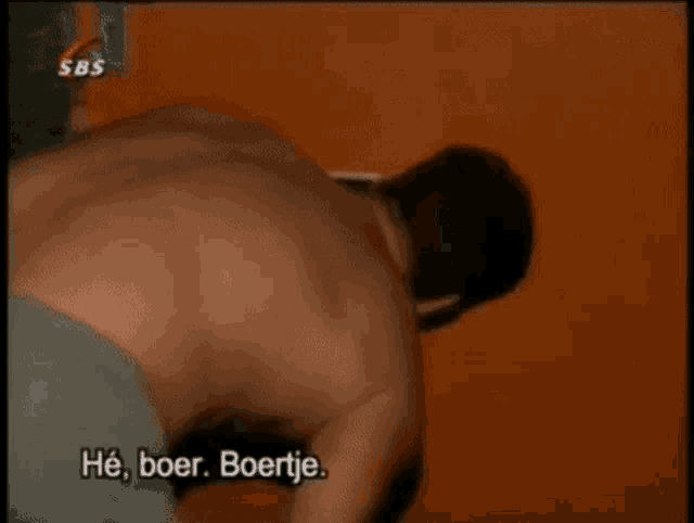 a man without a shirt is being interviewed by a sbs channel