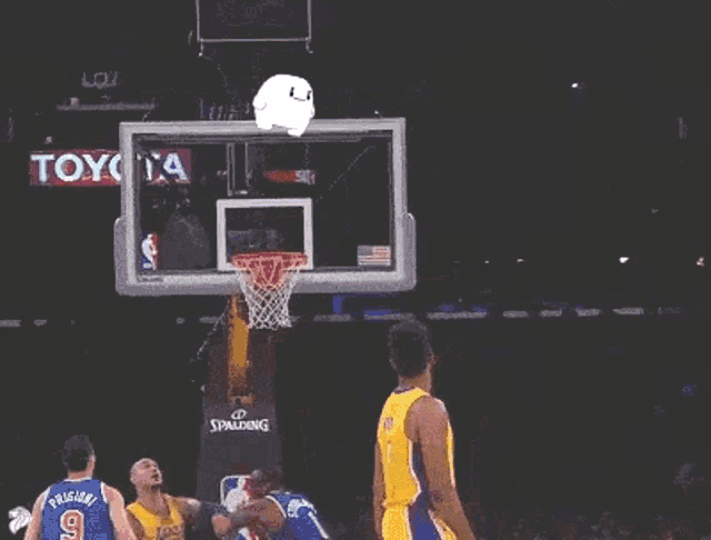 a basketball player for the lakers is throwing a ball into the hoop