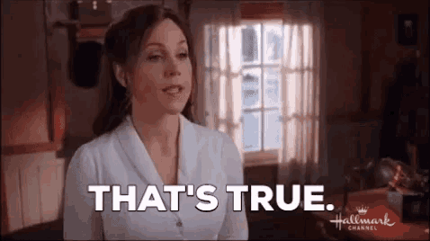 a woman is standing in front of a window and saying `` that 's true . ''