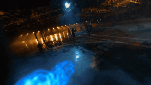 a blurry image of a person with a blue light coming out of their mouth