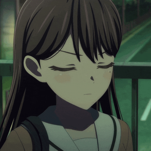 a close up of a girl 's face with a serious look on her face