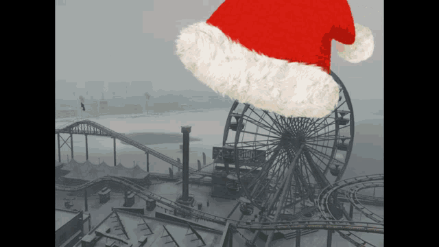 a santa hat is in front of a roller coaster and ferris wheel
