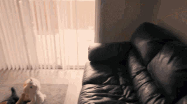 a black leather couch is in a living room