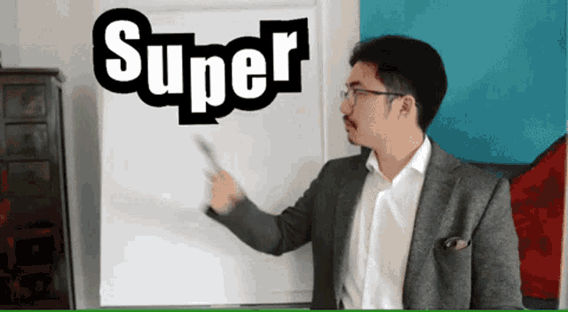 a man stands in front of a white board with the word super written on it