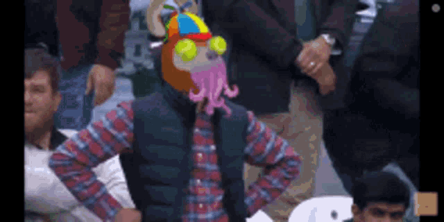 a man in a plaid shirt has a cartoon octopus head on his head