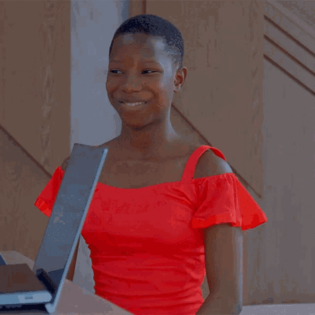 a woman in a red top is smiling and giving a thumbs up with the words thank you below her