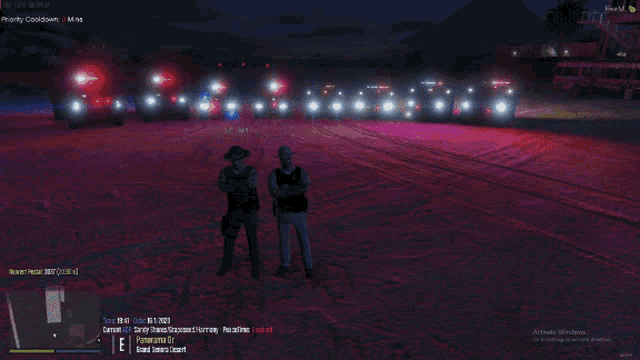 two police officers standing in front of a line of police cars