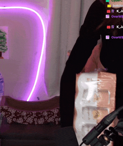 a person holding a stack of toilet paper in front of a screen that says overw8 on it