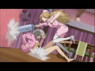 a girl in a pink shirt is kicking another girl in the stomach
