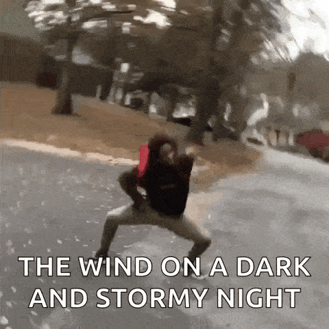 a man is standing on the side of the road with the words the wind on a dark and stormy night written below him .