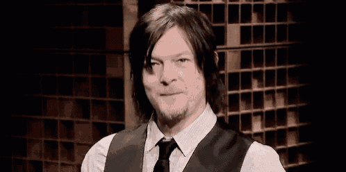 a man in a suit and tie is making a funny face .