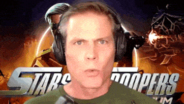 a man wearing headphones stands in front of a sign that says stars troopers