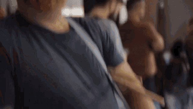 a blurry picture of a person 's torso and arm