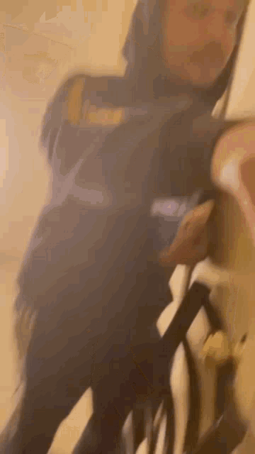 a blurry picture of a person wearing a hoodie and holding a bag .