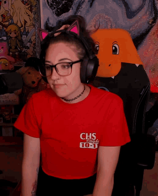 a woman wearing headphones and a red shirt that says chs radio 105.3