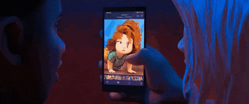 a man and a woman are looking at a cell phone with a picture of a little girl on it .