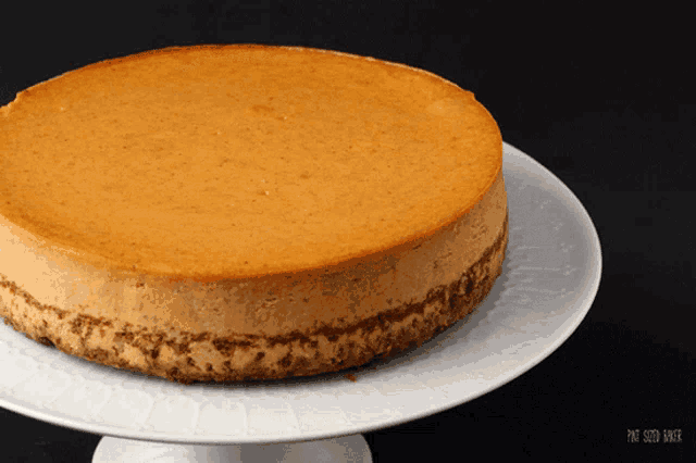 a cheesecake on a white plate that says pat smith baker on it