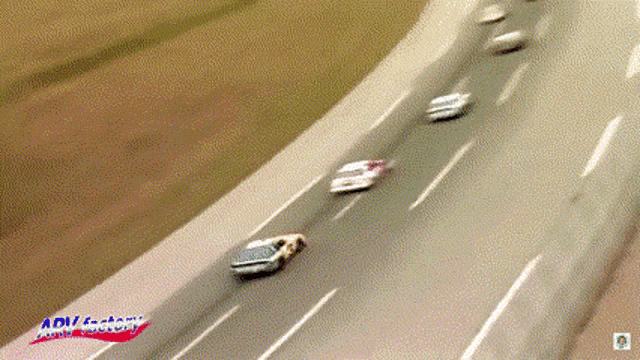 cars are driving down a highway with adi factory written on the bottom right