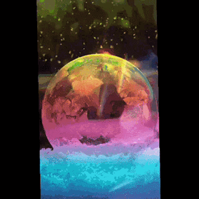a snow globe with a rainbow colored globe inside