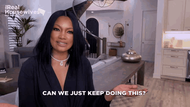 a woman says can we just keep doing this while standing in a living room