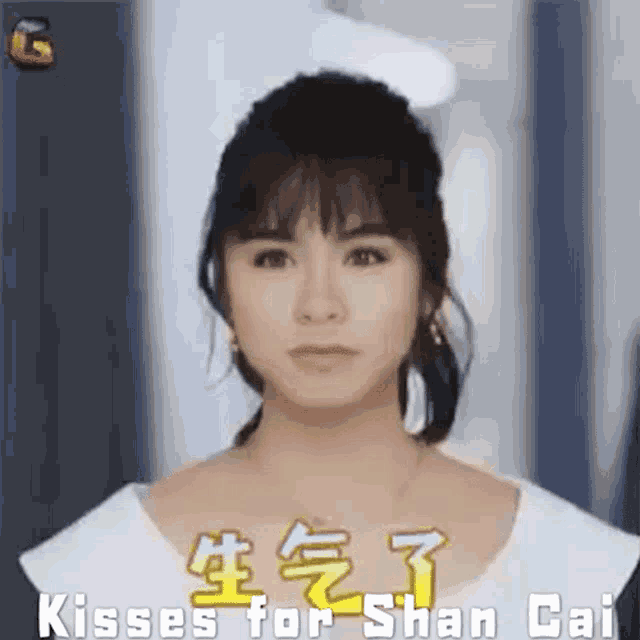 a close up of a woman 's face with the words kisses for shan gai written on it .