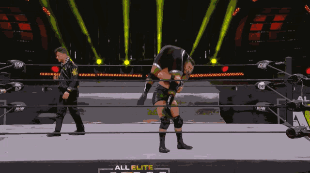 two wrestlers in a ring with the words all elite on the bottom right