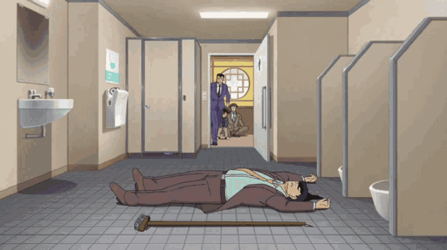 a man with a cane is laying on the floor in a public restroom