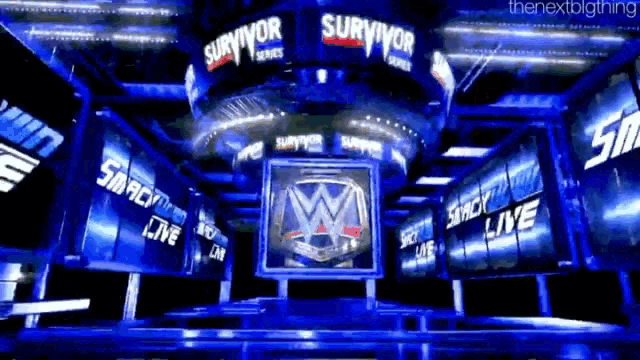 a smackdown live sign hangs from the ceiling of a wrestling arena