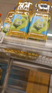 several bottles of extra virgin olive oil are on a shelf
