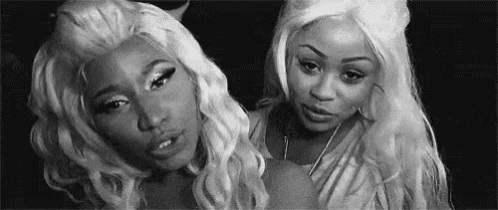 a black and white photo of two women with long blonde hair .