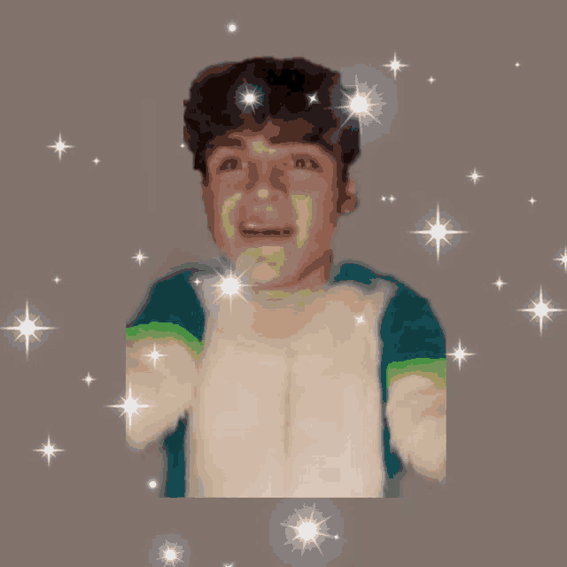 a boy in a green and white sweater is surrounded by sparkly stars