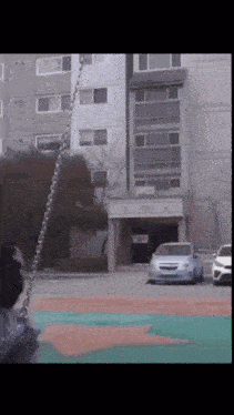 a white car is parked in front of a building with a sign that says ' a ' on it
