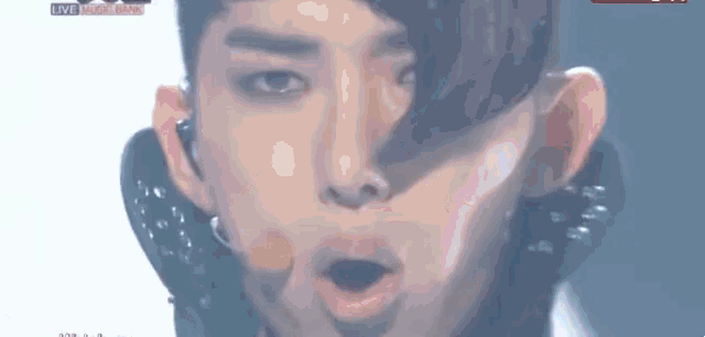 a close up of a man 's face with his mouth open and a shadow on his face .
