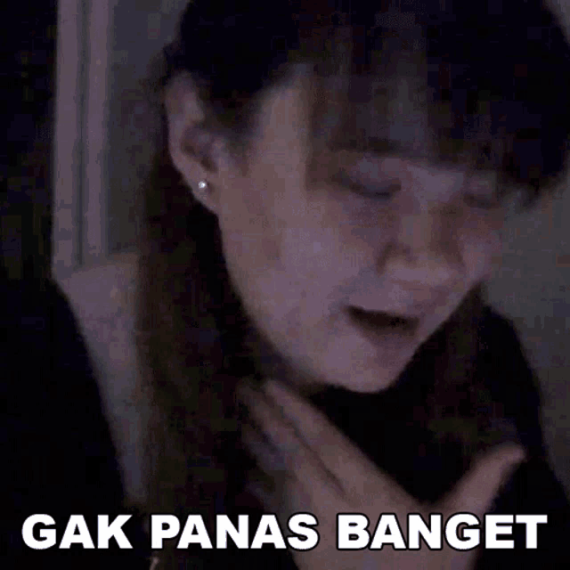 a woman is crying with the words " gak panas banget " written above her