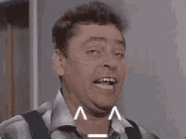 a man is making a surprised face with his mouth open .