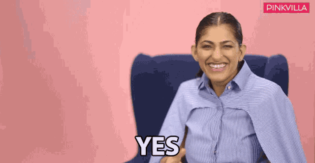 a woman sitting in a chair with the word yes written on her face