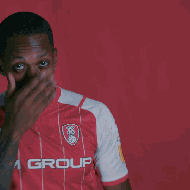 a soccer player wearing a red and white jersey with the word gro on it