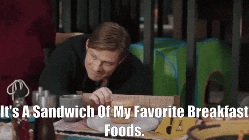 a man is eating a sandwich with the words " it 's a sandwich of my favorite breakfast foods " below him