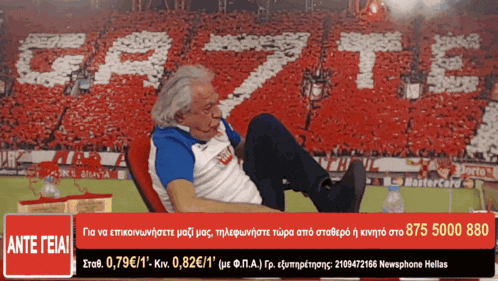 a man sits in front of a crowd with the word gazt written in white