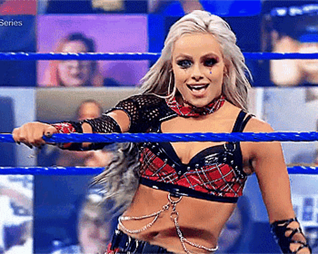 a woman in a plaid top is standing in a blue ring .