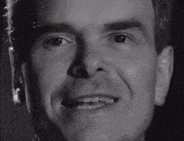 a close up of a man 's face with a smile on it
