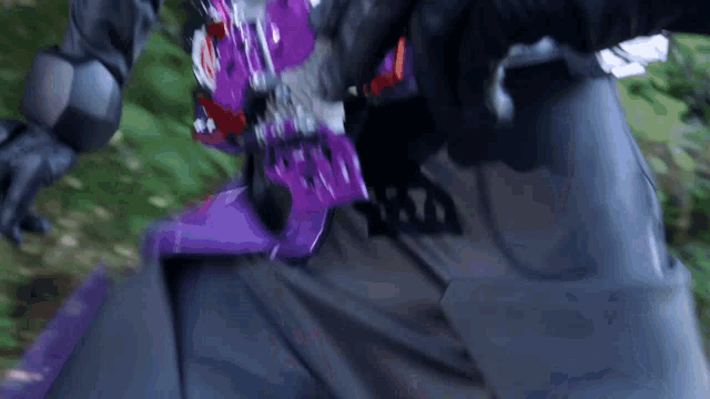 a person wearing a purple helmet and a black shirt with the word batman on it