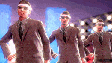 a group of men in suits and sunglasses are dancing together