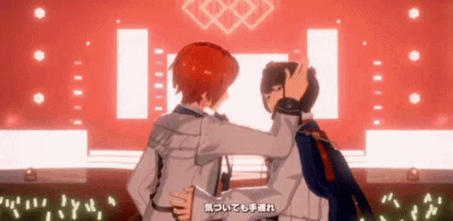 two anime characters are hugging each other in front of a red background .