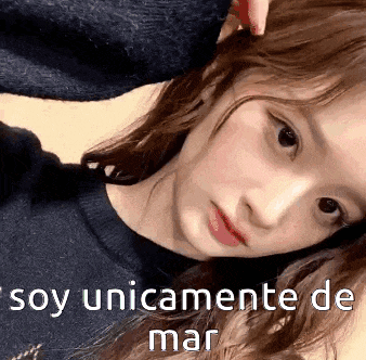 a close up of a woman 's face with the words soy unicamente de mar written on the bottom