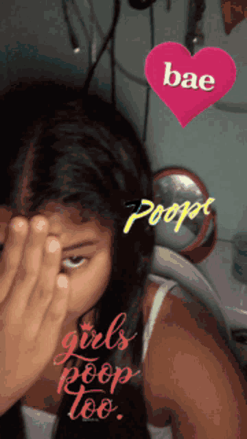 a girl covering her face with a pink heart that says bae poop girls poop too