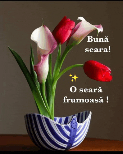 a bunch of flowers in a blue and white striped vase